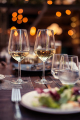 Two glasses with white wine in a restaurant
