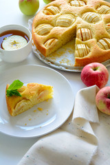 Slice of homemade apple pie on white plate. Tea time concept