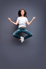 Fototapeta na wymiar Young brunett female practicing yoga levitate at the air. Calm g