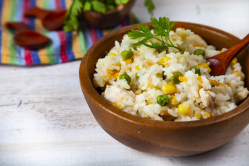 Boiled rice with vegetables in a wooden bowl