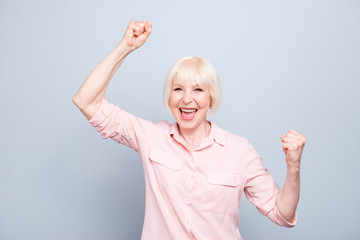 Old blonde glad excited cheerful lady smiling, laughing, raising