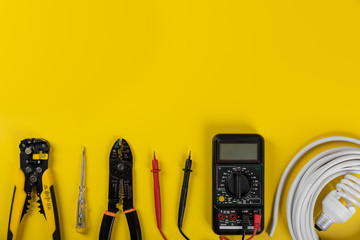 electrical installation tools on yellow background with copy space