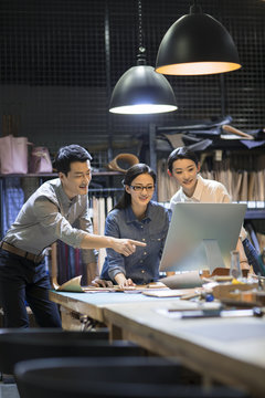 Confident leather craftspeople working in studio