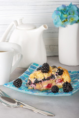 A piece of homemade baking berry pie lies on a mosaic glass plate.