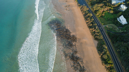 Aerial View of Waves and People and Beach Along Great Ocean Road, Victoria, Australia at Sunrise