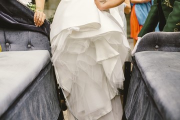 Detail of a white and elegant wedding dress.