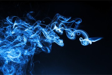 Blue smoke over black background