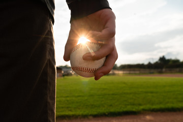 Teen boy holds baseball