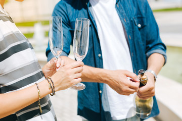 Alcoholic drink. Close up of empty glasses for champagne being in hands of a nice positive woman