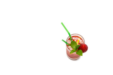 Glass with the soft strawberry drink decorated with strawberry and leaves of mint, the top view.