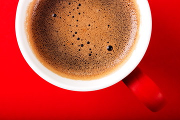 A cup of fragrant coffee on a red background for your design. Advertising coffee.