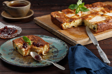 Homemade pear pie on rustic wooden table.