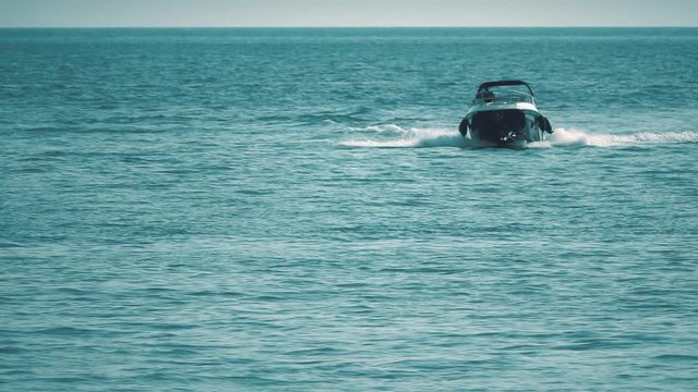 Slow motion shot of approaching motorboat at sea