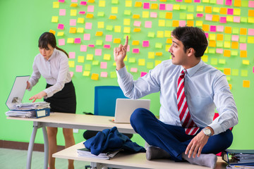 Man and woman in the office with many conflicting priorities in 