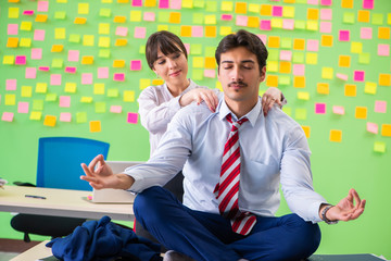 Man and woman in the office with many conflicting priorities in 