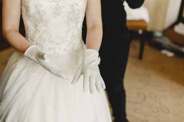 Detail of a white and elegant wedding dress.