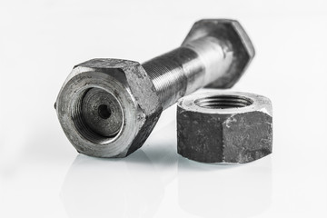 bolt and nut lying on a white background