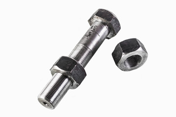 Threaded bolt and nut lying on a white background
