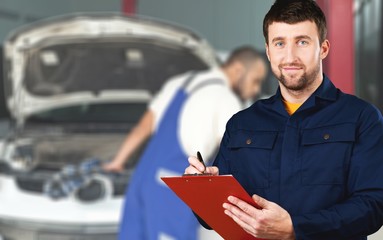 Delivery man with clipboard on light background