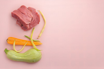 Natural raw ingredients for pet food on pink background.
