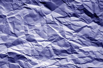 Fototapeta premium Crumpled sheet of paper in blue tone.