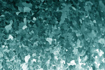 Metal surface with scratches in cyan tone.