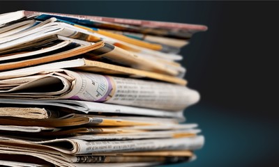 Pile of newspapers on white background
