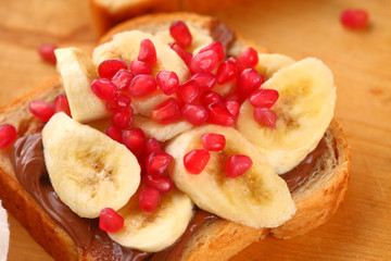 Chocolate and banana sandwich with pomegranate seeds on top