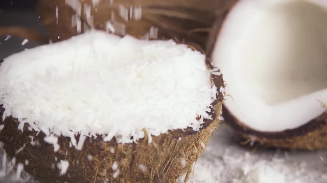 Slow motion a lot of coconut shavings to pour into the coconut half