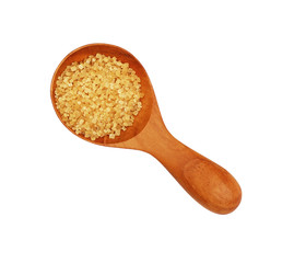 Close up scoop of brown cane sugar on white