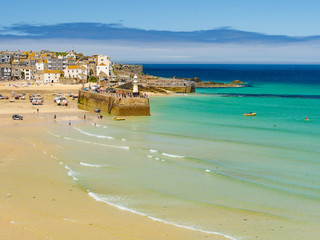 The golden sands and clear blue-green sea of St Ives, in Cornwall, England.