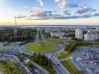 Aerial view on road ring in city at summer sunset