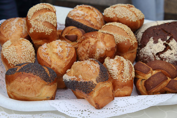 Fresh fragrant bread on the table, fresh homemade cakes close-up.