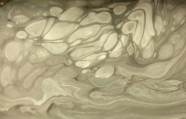 Gold marbling texture design. Beige and golden marble pattern. Fluid art.
