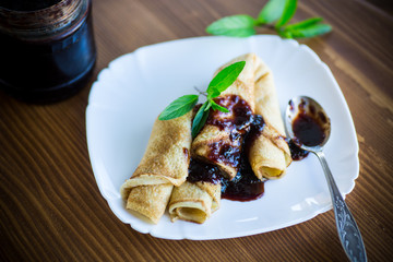 thin fried pancakes stuffed with jam in a plate