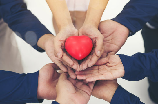 red heart on hands together collaborate of teamwork
