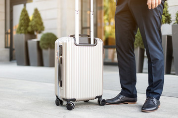 Man holding suitcase. businessman with luggage travels, goes to a business meeting