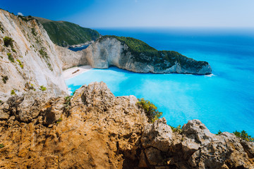 Rock Cliffs in front of Navagio beach Zakynthos. Shipwreck bay with turquoise water and white sand beach. Famous marvel landmark location in Greece