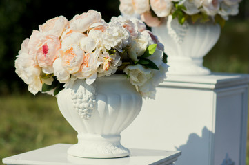 Beautiful floral wedding decor. Wedding ceremony on outdoor. Floral composition for wedding decorators