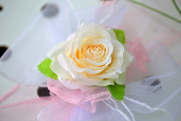 Obraz na płótnie Canvas Artificial rose decoration on a bride's dress