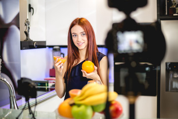 Young woman blogging and prepare fruit mix