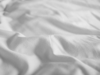 Smooth white crumpled bed sheet for lazy sunday morning background