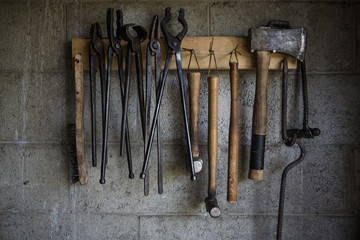 Close up of work tools hanging on a rack in the workshop