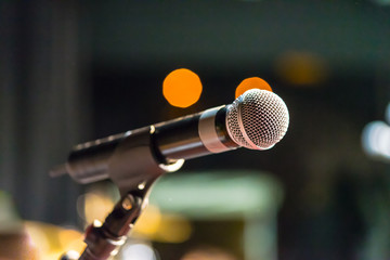 Microphone on stand with lights in the background