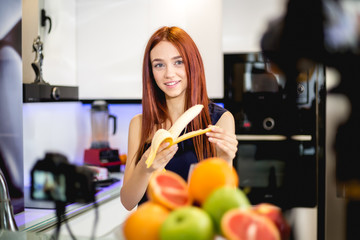Young woman blogging and prepare fruit mix