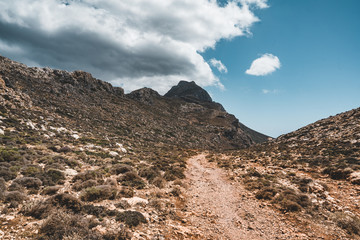Walking in the mountains. Hiking and tourist routes on the island of Crete, Greece. Way to famous Balos beach on a hot summer day. mediterranean sea landscape beach and mountains on Crete island