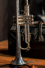 Trumpet standing on stage with leather bag in the background