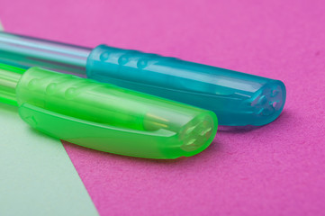 closeup of colorful ballpoint pens on color background