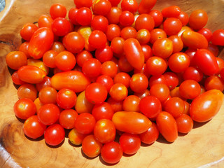 Fresh cherry tomatoes in a wooden bowl