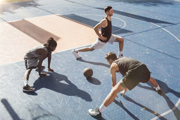 Basketball Players Stretching on the Court